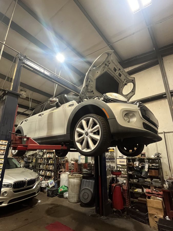 Mini Cooper raised on a lift for import repair in Athens, GA